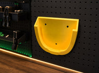 03 — LiftDock™ yellow PETG wall mount empty on graphite workshop wall
