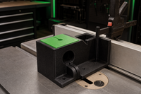 03 — Black dowel jig installed on a table saw with green template