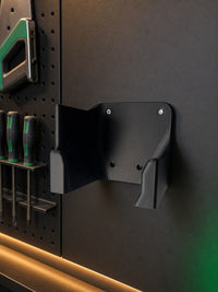 03 — SawSentry™ black PETG vertical saw holder empty on graphite workshop wall